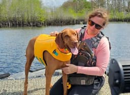 Beth Braun, certified K-9 handler, with one of the team's cadaver Vizslas on the water